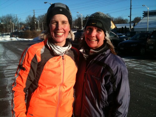 Rebecca (in Orange) with a frozen neck warmer and her running buddy Alison