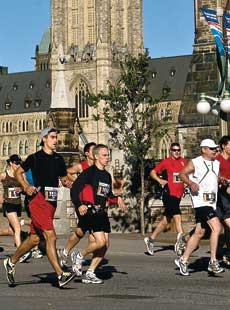 Competitors in the 2009 Canada Army Run Half-Marathon run past the Parliament Buildings in Ottawa.