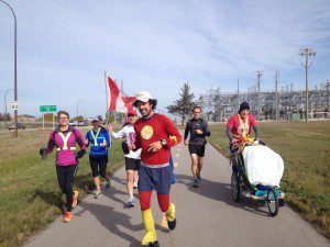 Jamie running into Winnipeg with local runners