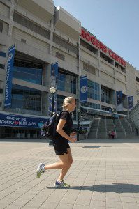 Alexis Brudnicki running past her workplace, Rogers Centre in Toronto.