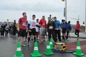Codi (in red), Eric (all black) and Calvin with blue top before the start of a half-marathon.