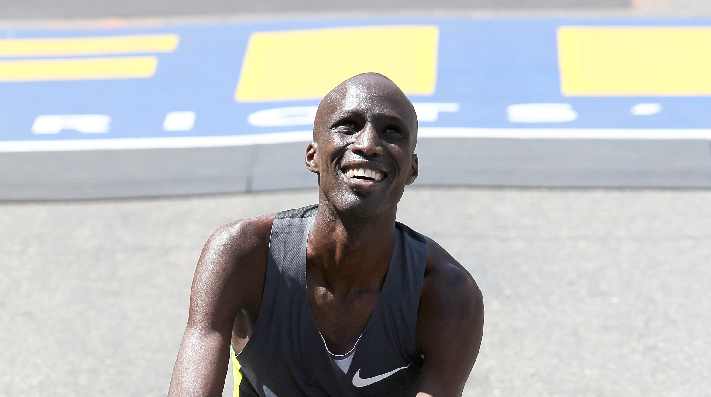 Wesley Korir touches the ground after winning the 2012 Boston Marathon Credit: photorun.net