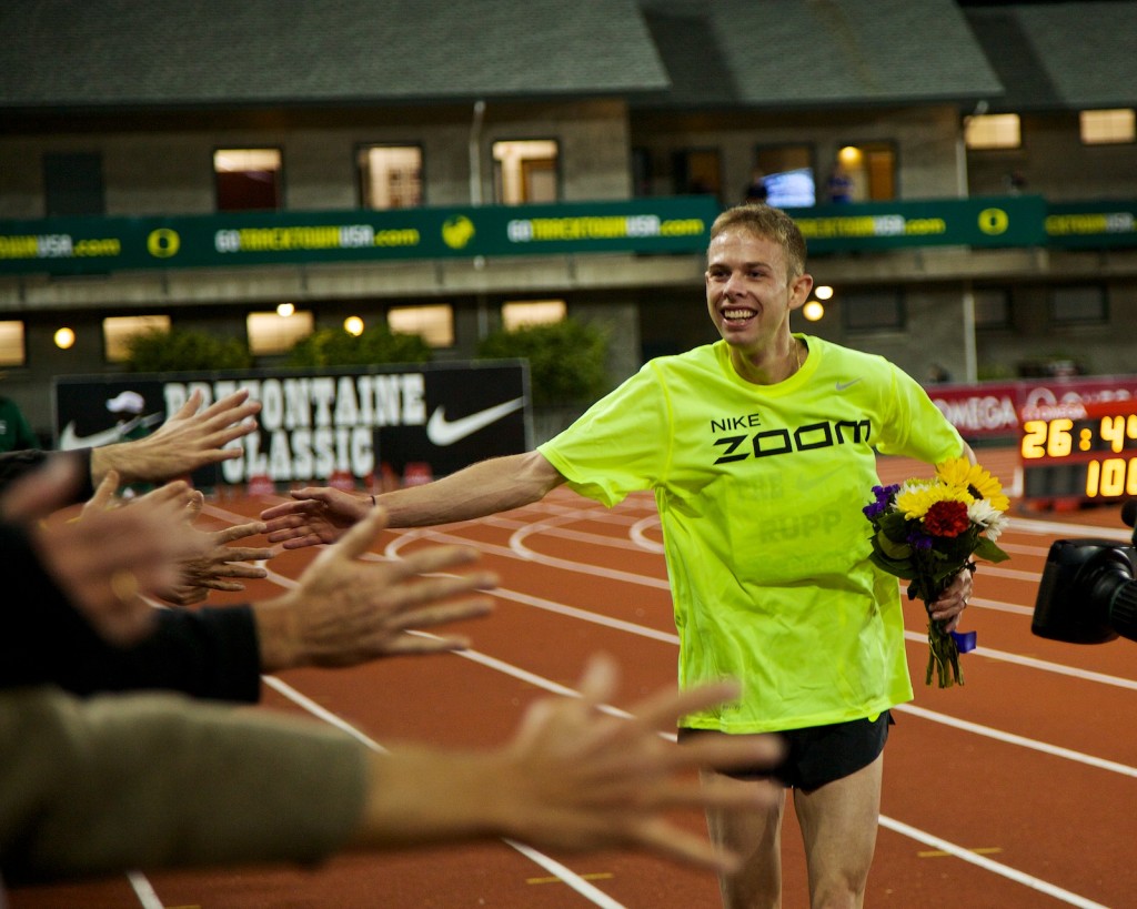 Galen Rupp high fives the audience after his American record run.