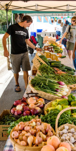 Customers buying fresh fruit and vegetables at the Buena Vista Colorado farmer's market