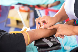 Arm of a donor donating blood at hemotransfusion station