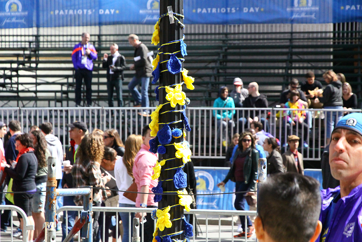 A post at the finish where a bomb was detonated in 2013 in wrapped is flowers.