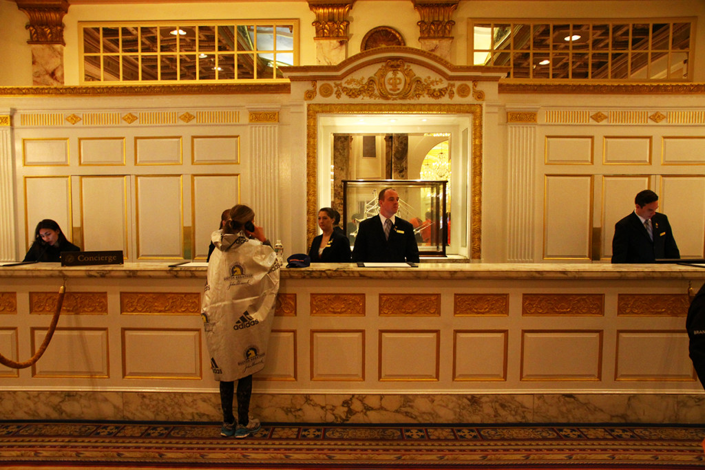 A runner uses the phone in the race hotel after the marathon. The usually posh Copley Square Fairmont is taken over by runners for the weekend.