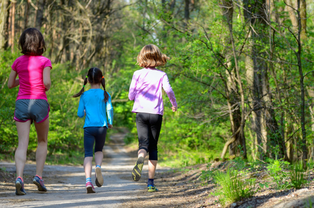 Family sport, active mother and kids jogging, running in forest