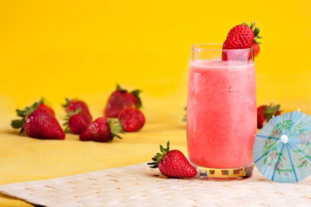 A fresh summer strawberry drink isolated on yellow