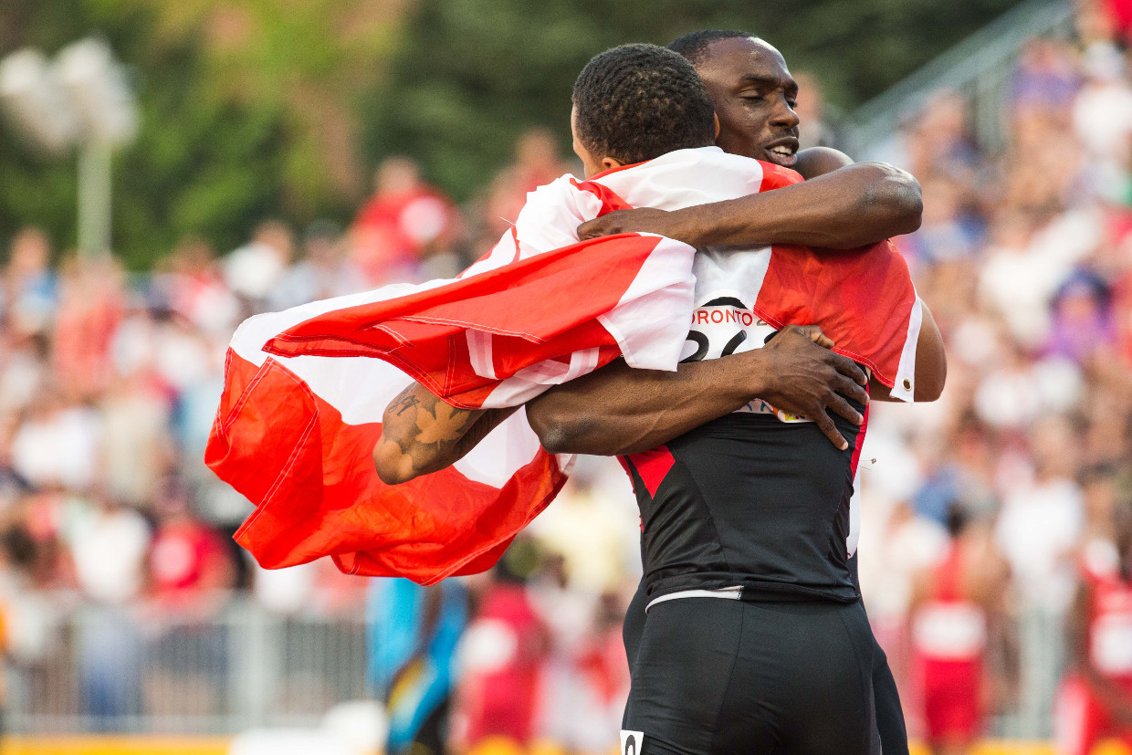 Andre De Grasse and teammate Brendon Rodney hug, believing they had won the men's 4x100m really. The team was later disqualified.