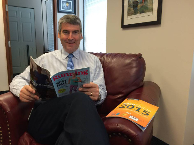 Nova Scotia Premier, Stephen McNeil reading Canadian Running Magazine and the 2015 Race Guide