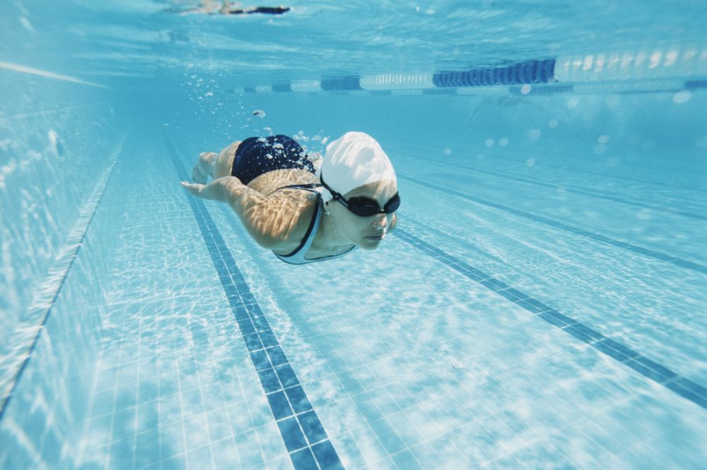 Young Woman Swimming in a Pool Underwater