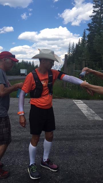Dave Proctor gets cooling water during cross-Canada speed trek in 2018