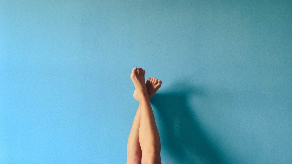 Legs and feet up a wall