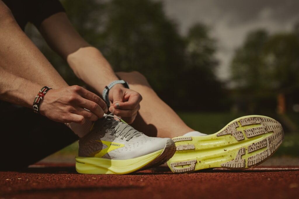 Runner tying shoes on track