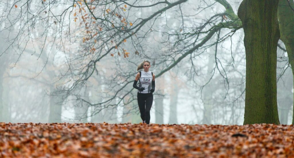 woman running in leaves