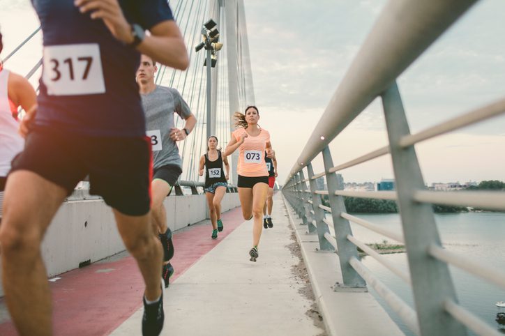 marathon runners on bridge