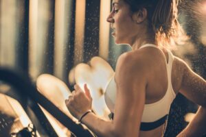Sweaty woman running on treadmill