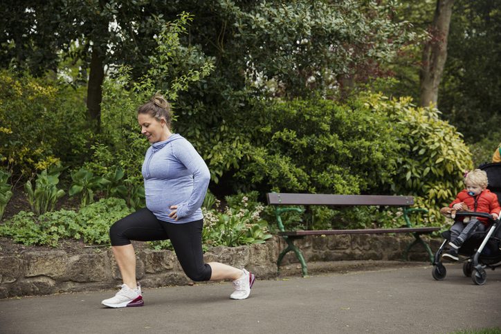 woman runner with stroller doing lunges
