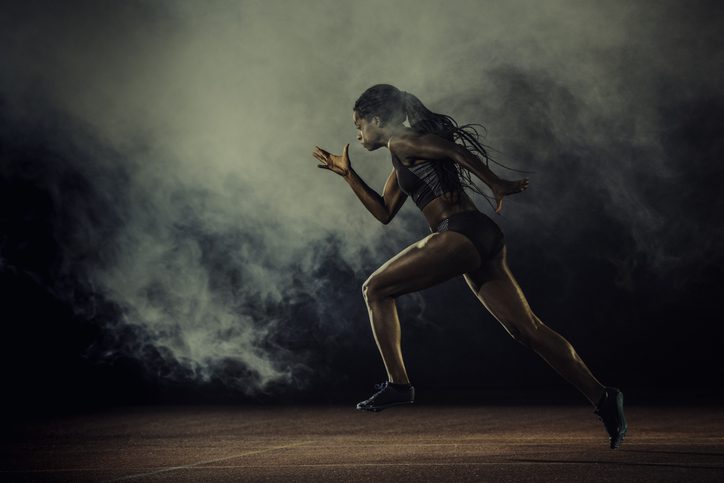 woman sprinting on track