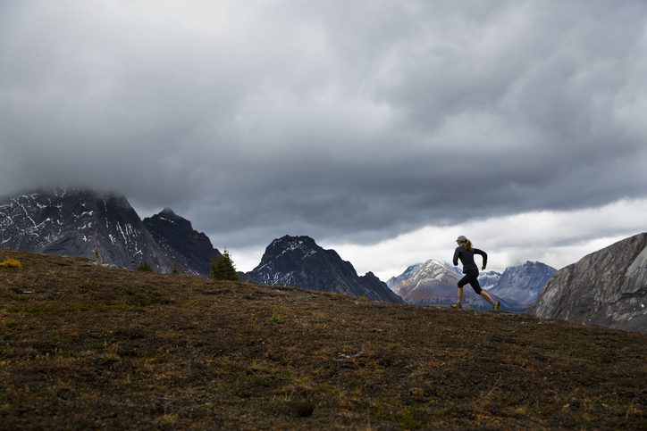 woman running in rocky mountains