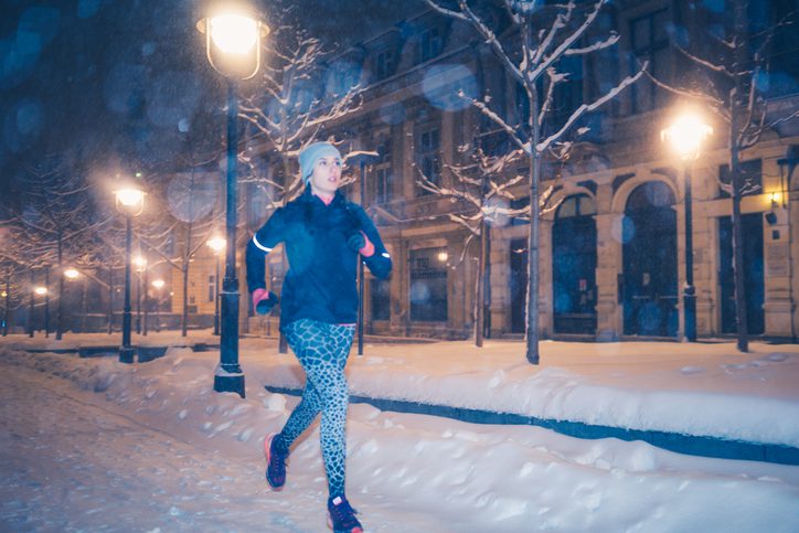 woman running on a snowy night