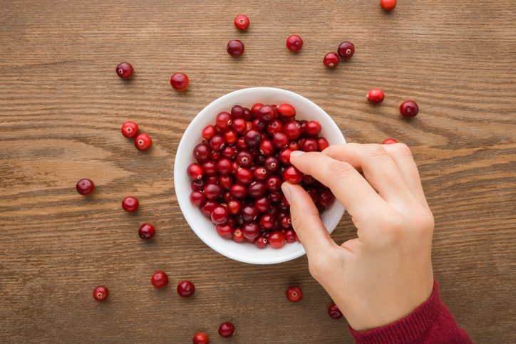 person eating bowl of cranberries