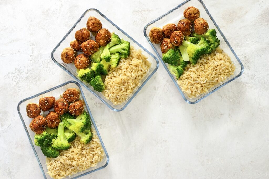 Meatballs and broccoli and rice lunch boxes cooked in advance and ready to be frozen or to be served for lunch, view from above